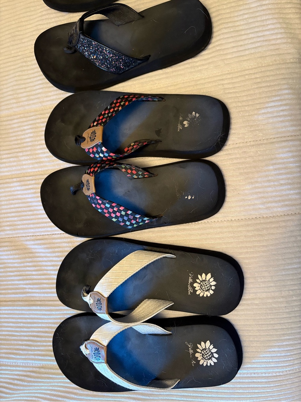 4 pairs of flip flops and one pair of sneakers size 8 1/2